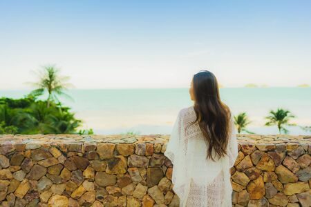 Portrait beautiful young asian woman looking sea beach ocean for relax in holiday vacation travel conceptの写真素材