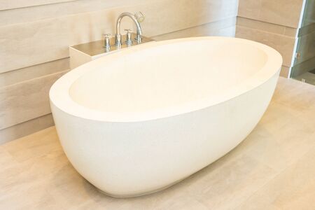 Beautiful luxury elegance white bathtub and water faucet decoration in bathroom interiorの写真素材