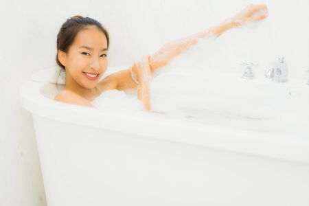 Portrait beautiful young asian woman relaxing bathtub in bathroom interior