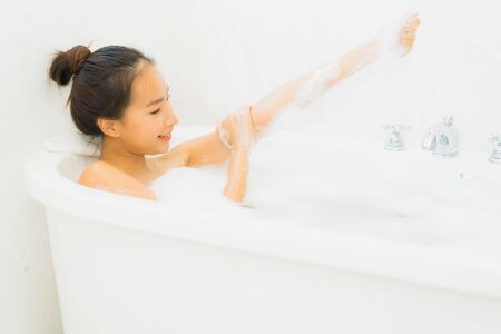 Portrait beautiful young asian woman relaxing bathtub in bathroom interior