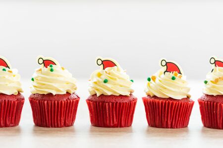 Sweet dessert with cupcake red velvet and chocolate christmas hat on topの写真素材