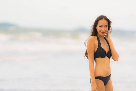 Portrait beautiful young asian woman wear bikini on the beach sea ocean for leisure relax in holiday vacatiom timeの写真素材
