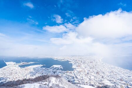 Beautiful landscape and cityscape from Mountain Hakodate for look around city skyline building and architecture with blue sky white cloudの写真素材