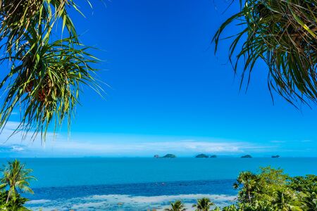 Beautiful tropical sea ocean with coconut palm tree on blue sky white cloud for holiday vacation travel backgroundの写真素材