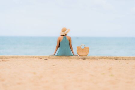 Beautiful portrait young asian women happy smile relax around beach sea ocean in holiday vacation conceptの写真素材