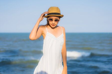 Portrait beautiful young asian woman happy smile relax around neary beach and sea for leisure travel and vactionの写真素材