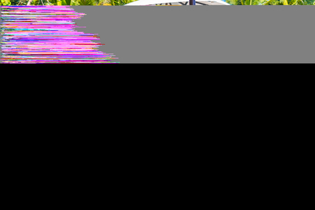 Umbrella and chair around swimming pool in hotel resort neary sea ocean beach for leisure vacation travel conceptのeditorial素材