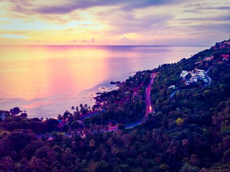 Aerial view of beautiful tropical beach and sea with palm and other tree in koh samui island Thailand at sunset time for vacation and travelの写真素材