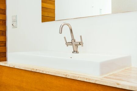 Faucet or water tap and white sink or washbasin decoration in bathroom interior