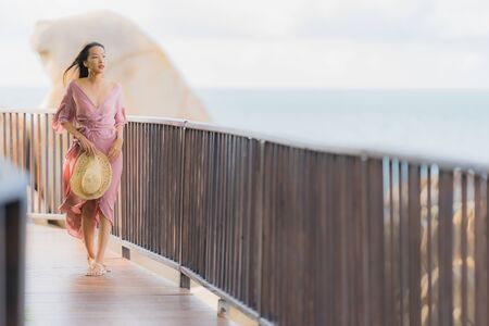 Portrait beautiful young asian woman looking sea beach ocean for relax in holiday vacation travel conceptの写真素材