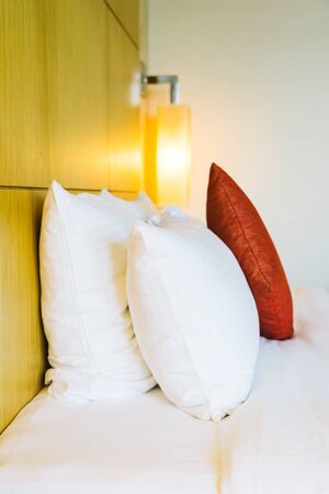 White comfortable pillow on bed decoration in hotel bed room interiorの写真素材