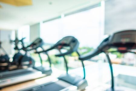 Abstract blur and defocus fitness equipment in gym room interior for background