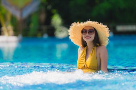 Portrait beautiful young asian woman leisure relax smile and happy around swimming pool in hotel resort for holiday vacation tripの写真素材