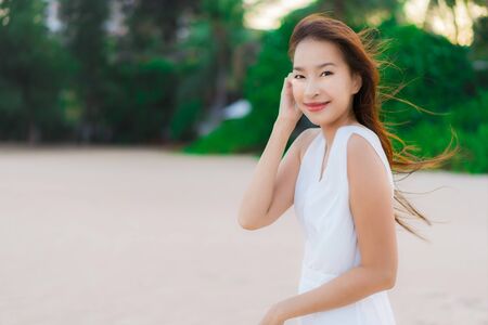 Portrait beautiful young asian woman happy and smile on the beach sea and ocean for travel and vacationの写真素材