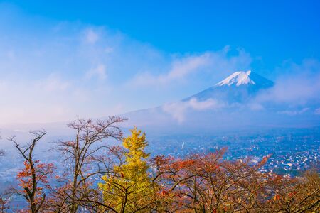 Beautiful landscape of mountain fuji around maple leaf tree with white cloud and blue sky in autumn season at Yamanashi Japanの写真素材