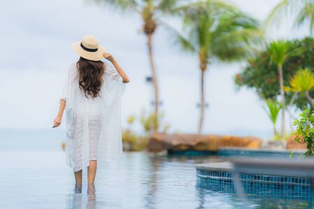 Portrait beautiful young asian woman smile happy relax around swimming pool in hotel resort for holiday vacationの写真素材