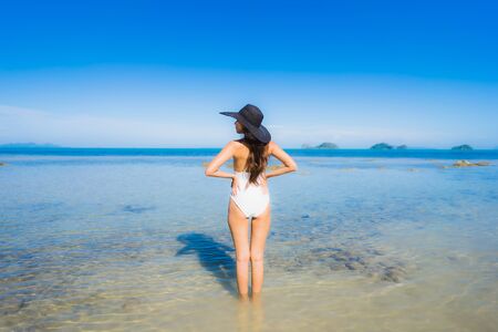 Portrait beautiful young asian woman looking sea beach ocean for relax in holiday vacation travel conceptの写真素材