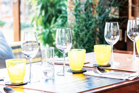 Wine glass with dining set prepare for breakfast lunch or dinner on table in restaurant and cafeの写真素材
