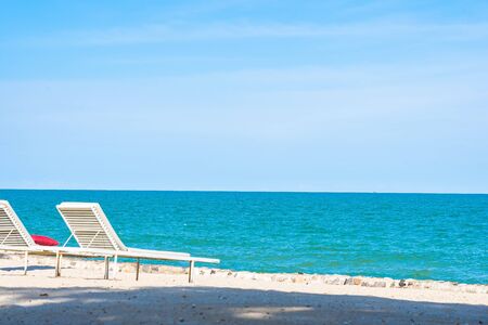 Beautiful umbrella and chair around beach sea ocean with blue sky for travel vacation