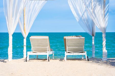 Beautiful umbrella and chair around beach sea ocean with blue sky for travel vacation
