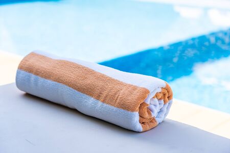 Towel on bed around swimming pool in hotel resort for relaxの写真素材