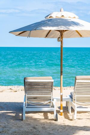 Beautiful umbrella and chair around beach sea ocean with blue sky for travel vacation