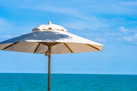 Beautiful umbrella and chair around beach sea ocean with blue sky for travel vacationの写真素材
