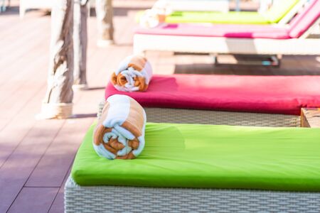Towel on bed around swimming pool in hotel resort for relaxの写真素材
