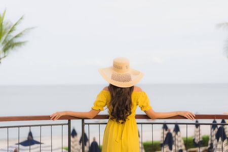 Portrait beautiful asian women happy smile relax on the tropical beach sea ocean in holiday vacationの写真素材
