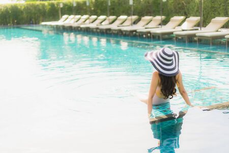 Portrait beautiful asian women happy smile relax around swimming pool in hotel resort for holiday...