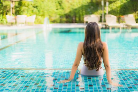 Portrait beautiful asian women happy smile relax around swimming pool in hotel resort for holiday vacationの写真素材