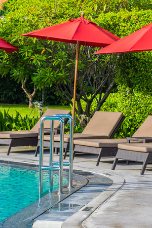 Beautiful umbrella and chair around outdoor swimming pool in hotel resort for holiday vacation travel backgroundのeditorial素材