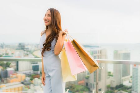 Portrait beautiful young asian woman happy and smile with shopping bag from department store mallの写真素材