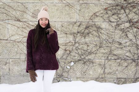 Beautiful young asian woman smiling happy with travel in snow winter season at Hokkaido Japan