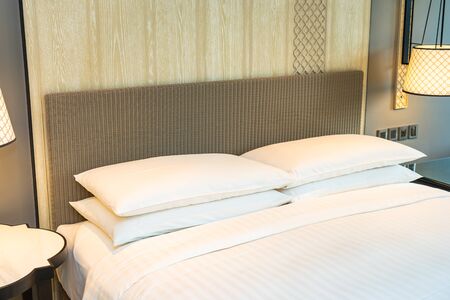 White comfortable pillow on bed decoration interior of bedroom