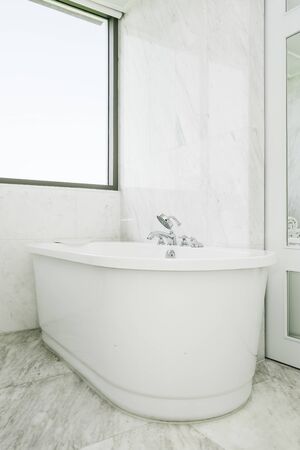Beautiful luxury white and clean bathtub decoration in bathroom interiorの写真素材