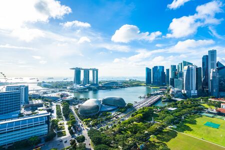 Beautiful architecture building exterior cityscape in Singapore city skyline with white cloud on blue skyの写真素材
