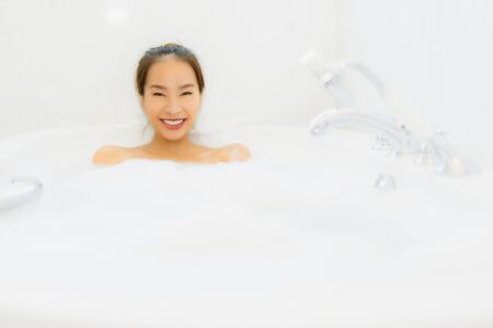 Portrait beautiful young asian woman relaxing bathtub in bathroom interiorの写真素材