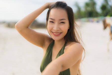 Portrait beautiful asian women happy smile relax on the tropical beach sea ocean in holiday vacationの写真素材
