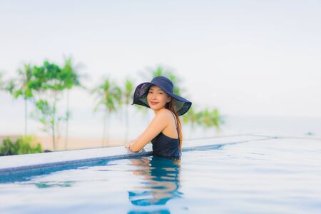 Portrait beautiful young asian women happy smile relax outdoor swimming pool in hotel resort in vacationの写真素材