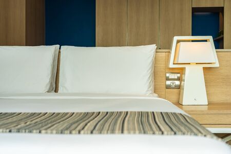 Pillow and blanket on bed with light lamp decoration interior of bedroomの写真素材