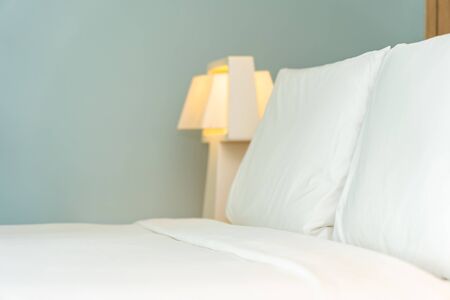 Pillow and blanket on bed with light lamp decoration interior of bedroomの写真素材