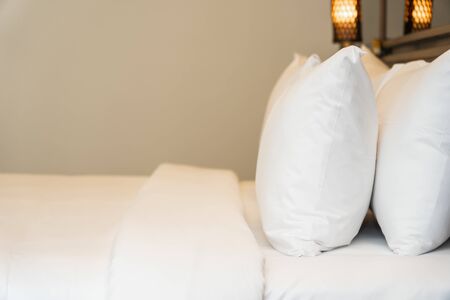 Pillow and blanket on bed with light lamp decoration interior of bedroomの写真素材