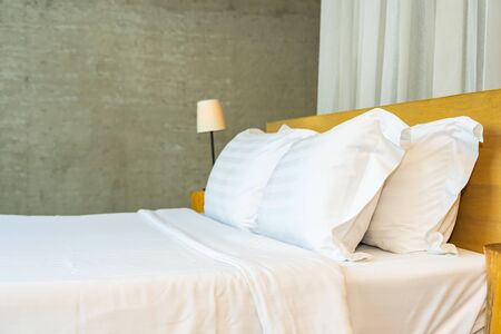 Pillow and blanket on bed with light lamp decoration interior of bedroomの写真素材
