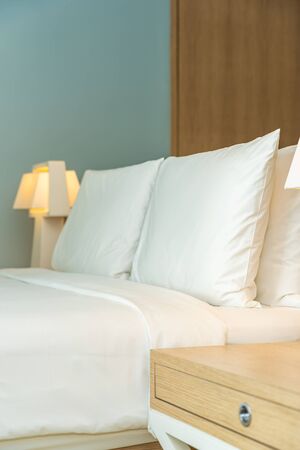 Pillow and blanket on bed with light lamp decoration interior of bedroomの写真素材