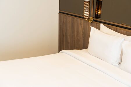 Pillow and blanket on bed with light lamp decoration interior of bedroomの写真素材