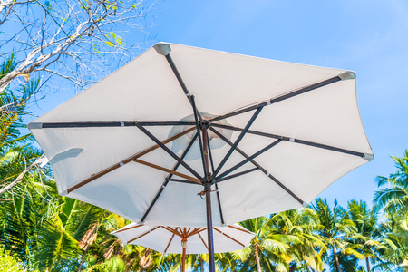 Beautiful landscape of sea ocean on sky with umbrella and chair around luxury outdoor swimming pool in hotel resort for leisure travel and vacationのeditorial素材