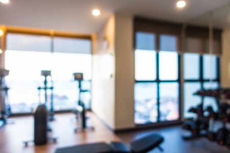 Abstract blur gym room interior with fitness equipment for backgroundの写真素材