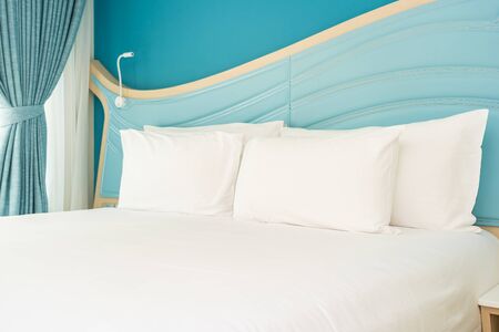 White comfortable pillow on bed decoration interior of bedroom