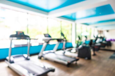 Abstract blur gym room interior with fitness equipment for backgroundの写真素材